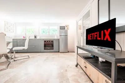 a kitchen with a flat screen tv on a table at Ambiance sudiste , piscine, boule, farniente AG in Carcassonne