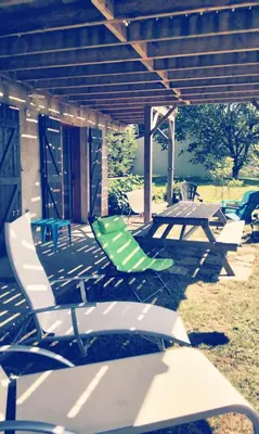 a group of chairs and a picnic table on a patio at Chez Rosa in Pradelles-Cabardès