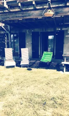 a group of three chairs sitting in the grass at Chez Rosa in Pradelles-Cabardès