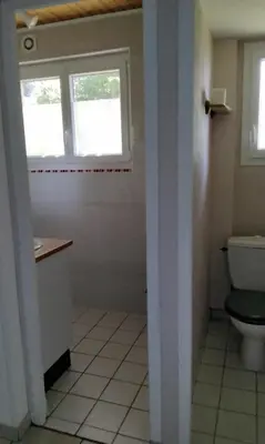 a bathroom with a toilet and a window at Chez Rosa in Pradelles-Cabardès