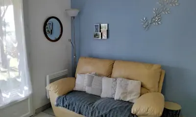 a couch with pillows on it in a room at Chez Rosa in Pradelles-Cabardès