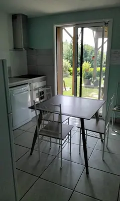 a kitchen with a table and chairs and a window at Chez Rosa in Pradelles-Cabardès