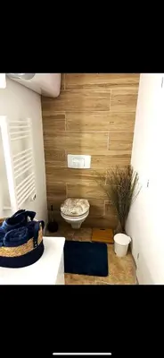 a room with a room with a toilet and a table at Apparemment Résidence la palmeraie in Lapalme