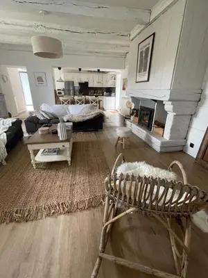 a living room with a couch and a fireplace at Maison de charme in Fontrieu