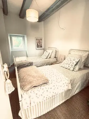 a bedroom with two beds and a ceiling at Maison de charme in Fontrieu