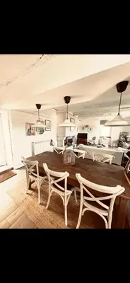 a dining room with a table and two chairs at Maison de charme in Fontrieu