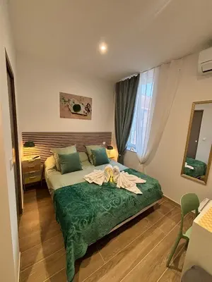 a bedroom with a bed with a flower on it at La Jade in Narbonne