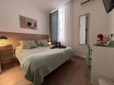 a bedroom with a bed with a large window at La Jade in Narbonne