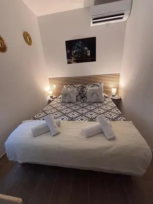 a small bedroom with a bed in a room at La Topaze in Narbonne