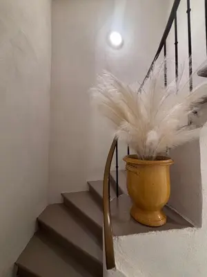 a staircase with a vase with feathers in it at La Saphir in Narbonne