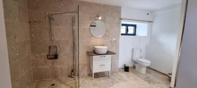 a bathroom with a shower and a toilet at La Métairie du Château, Elie in Aussillon