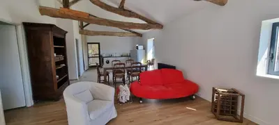 a living room with two chairs and a table at Métairie du Château Berthe in Aussillon