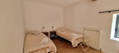 a room with two beds and a window at Métairie du Château Berthe in Aussillon