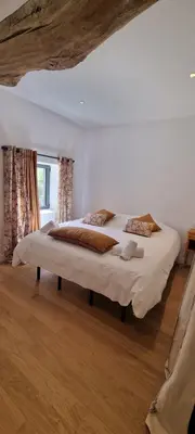 a bedroom with a large bed in a room at Métairie du Château Berthe in Aussillon