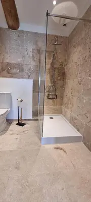 a bathroom with a shower with a glass door at Métairie du Château Berthe in Aussillon