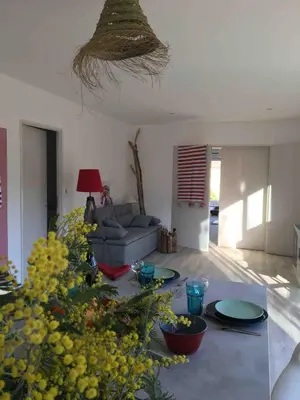 a living room with a couch and a table at Villa Et au milieu coule un ruisseau - Piscine, jacuzzi privé, boulodrome in Berlou