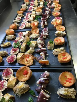 a row of trays filled with different types of food at Villa Et au milieu coule un ruisseau - Piscine, jacuzzi privé, boulodrome in Berlou