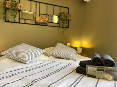 a bedroom with a bed with towels on it at Bel appartement avec piscine et vue bateaux in Gruissan