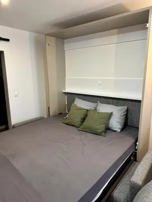 a bed in a room with two pillows on it at Beautiful Modern Studio in Carcassonne