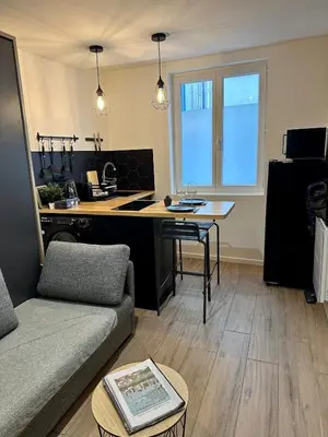a kitchen and living room with a couch and a table at Beautiful Modern Studio in Carcassonne