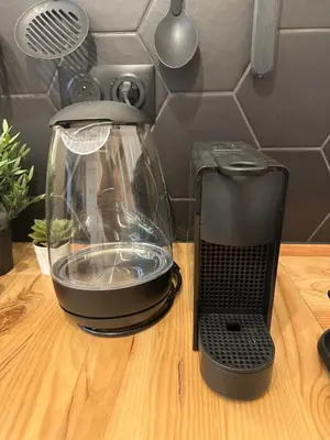 a blender sitting on a wooden table with a fish tank at Beautiful Modern Studio in Carcassonne