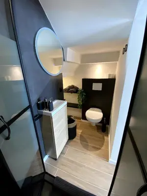 a small bathroom with a toilet and a mirror at Beautiful Modern Studio in Carcassonne