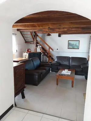 a living room with a couch and a table at La Bergerie Maison familiale in La Salvetat