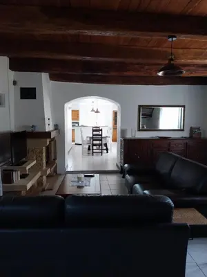a living room with a couch and a table at La Bergerie Maison familiale in La Salvetat