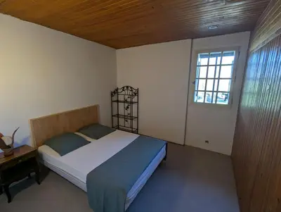 a bedroom with a bed and a window at La Bergerie Maison familiale in La Salvetat