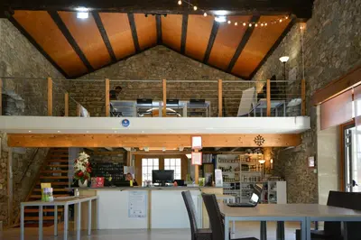 a building with a loft with tables and chairs at La Résidence du Château de Jouarres in Azille