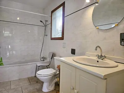 a bathroom with a sink and a toilet and a tub at La Cerisette in Félines-Minervois