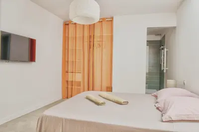 a bedroom with a bed with two towels on it at Villa Louise in Lapalme
