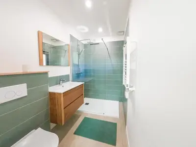 a bathroom with a toilet and a sink and a shower at Villa Louise in Lapalme