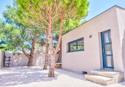 a building with a tree and stairs in front of it at Villa Louise in Lapalme
