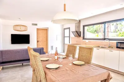 a kitchen and dining room with a table and chairs at Villa Louise in Lapalme