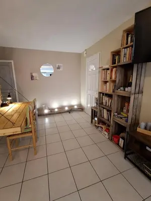 a living room with a table and bookshelves at Family villa in Salles-d'Aude in Salles-dʼAude