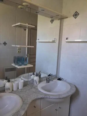 a bathroom with two sinks and a mirror at Family villa in Salles-d'Aude in Salles-dʼAude