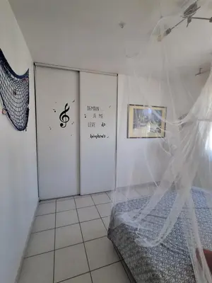 a bedroom with a bed and a wall with writing at Family villa in Salles-d'Aude in Salles-dʼAude