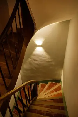 a stairway with a light at the top of a staircase at Ostal de la placette in Padern