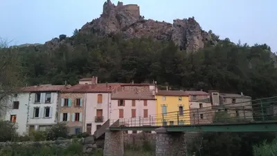 a bridge over a city with a mountain in the background at Ostal de la placette in Padern