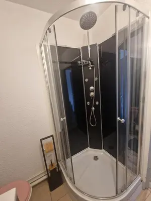 a shower in a room with a mirror at Apartment T2 Gruissan in Gruissan
