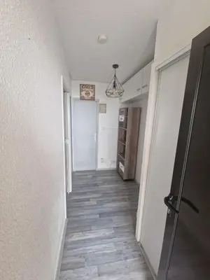 a hallway of a room with a door and a kitchen at Apartment T2 Gruissan in Gruissan