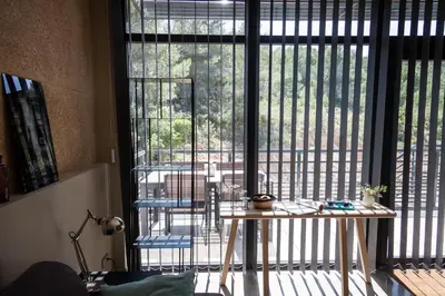 a room with a table and a large window at Gîte au cœur des vignes, vue sur le Minervois in Bize-Minervois