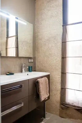 a bathroom with a sink and a mirror at Gîte au cœur des vignes, vue sur le Minervois in Bize-Minervois