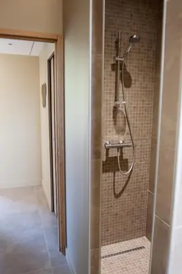 a shower in a bathroom with a glass door at Gîte au cœur des vignes, vue sur le Minervois in Bize-Minervois