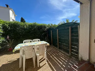 a table and chairs sitting on a patio at Le Ponant - Appartement proche du port et de la mer in Gruissan
