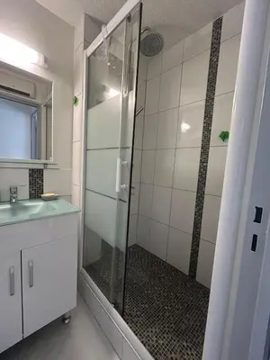 a bathroom with a shower with a glass door at Le Ponant - Appartement proche du port et de la mer in Gruissan