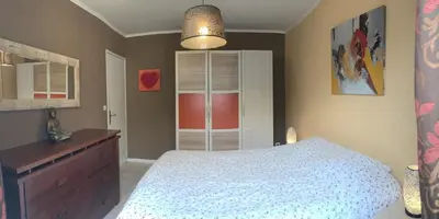 a bedroom with a white bed and a dresser at Villa privée Un vrai havre de paix in Limoux