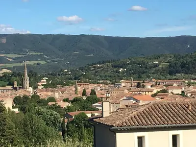 a view of a town with mountains in the background at Villa privée Un vrai havre de paix in Limoux