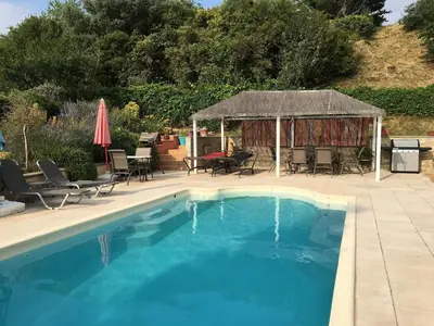 a swimming pool with a gazebo and a table and chairs at Villa privée Un vrai havre de paix in Limoux